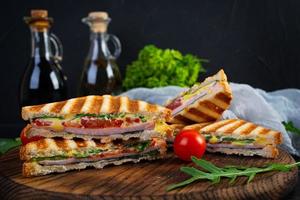 Sandwich with ham, cheese, mustard leaves, tomatoes and onion. Tasty club sandwiches photo