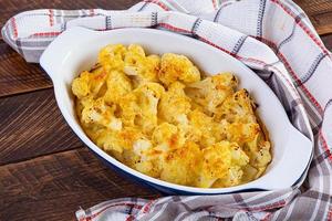 Diet food. Baked cauliflower with cheese, cream and eggs photo