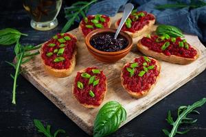 Bruschetta with grated beetroot, herbs and caramelized onion photo