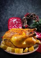 Roasted chicken and potato with Christmas decoration. Traditional food for Christmas or Thanksgiving day photo