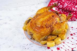 Roasted chicken and potato with Christmas decoration. Traditional food for Christmas or Thanksgiving day photo