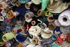 Multicolored fabrics for sale in the shop window. photo