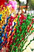 Branches of painted yellow, pink, red, blue and green colors willow on a flower market. Hue, Vietnam. photo