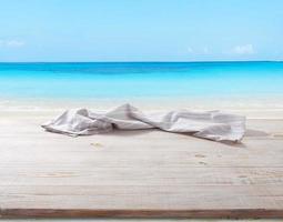 White napkin, table cloth on wooden deck mockup. photo