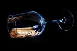 bamboo wooden toothpicks in glass jar, wine glass. in bucket. toothpicks on black background. front view toothpicks, dropped from hand, place for text, photo