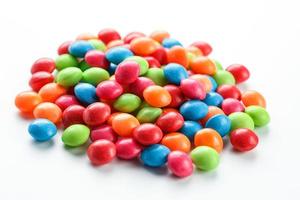 Rainbow-colored candies, multicolored close-up, texture and repetition of dragee photo