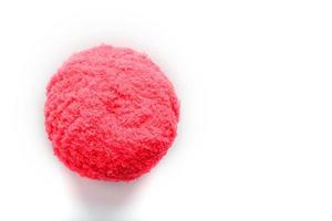 Pink wool ball on white background with free space for text. photo