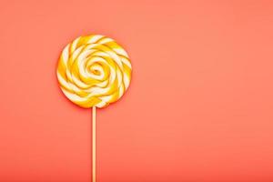 Colorful round Lollipop on pink background. Minimal concept with copy space. photo