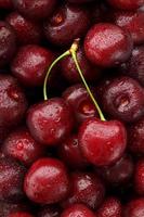 Ripe and fresh berries of a sweet cherry with water drops closeup. photo