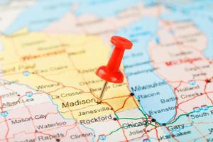 Red clerical needle on a map of USA, Michigan and the capital Lansing. Close up map of Michigan with red tack photo