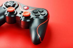 Game controller controller on red background. Device to control and control the game. close up photo