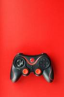 Game controller controller on red background. Device to control and control the game. photo