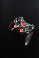 Game controller gamepad on black background. Device to control and control the game. photo