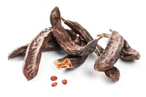 Carob carob fruit and seeds on white background. Isolate. photo