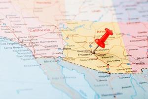 Red clerical needle on a map of the USA, Arizona and the capital Phoenix. Close up map of orizona with red tack photo