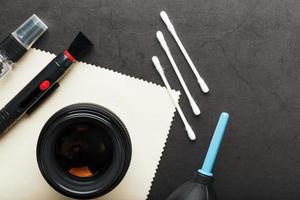 A set of tools to take care of your camera lenses on a dark background. photo