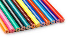 Colored pencils in a row on a white background, free space for text. photo