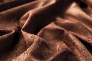 Brown velor textural background pattern. Gorgeous elastic velor fabric has a velvet pile, shine and texture. photo