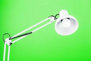 Office table lamp on green background with space for text and idea concept photo