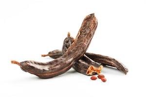 Carob carob fruit and seeds on white background. Isolate. photo