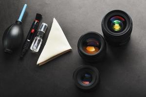 A set of tools to take care of your camera lenses on a dark background. photo