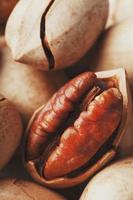 Pecan nuts close-up, macro as the background on the whole screen. photo