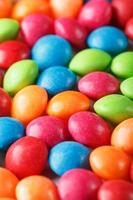 Rainbow colors of multicolored candies close-up, texture and repetition of dragee photo