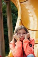 Teenage Girl is Sadly Alone in the Playground photo