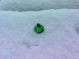 Christmas items and toys on white snow photo