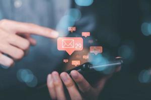young man holding a smartphone Displays global communication network connections, cyberspace technology, online information exchange, internet of things, Notifications from applications photo