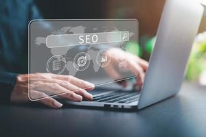 Marketers use laptops to analyze SEO, optimization analytics tools concepts. search engine ranking Social media sites based on results analytics data, effective keyword selection. photo