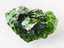 rough crystal of Chrome Diopside gemstone on white photo