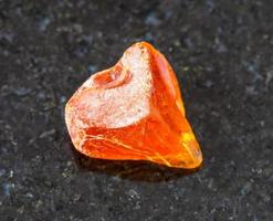 piece of Amber gemstone on black photo