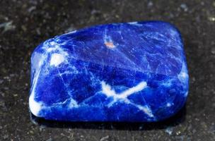 polished Sodalite rock on black photo