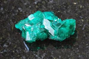 rough Dioptase crystal of gemstone on dark photo