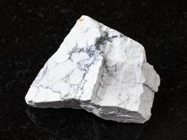 white Howlite stone on black granite photo