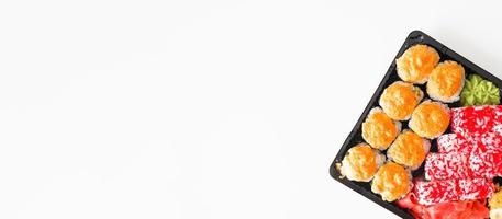 Set of sushi and rolls in a plastic container, top view. Japanese traditional food banner, copy space photo