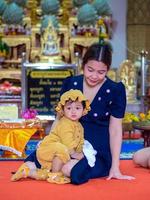 Asian mother and son of Thai nationality in temple at Thung Saliam temple or Wat Thung Saliam, Thung Saliam, Sukhothai, Thailand. photo