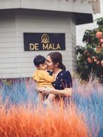 Asian mother and son of Thai nationality and colorful grass at De mala Cafe, Thung Saliam, Sukhothai, Thailand. photo