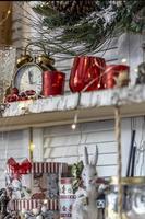 Table in the kitchen with kitchen utensils and shelves decorated with Christmas toys photo