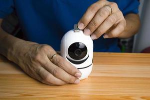 Conceptual man operating ip camera photo