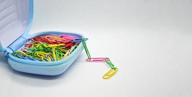 Colorful paperclips in blue pockets photo