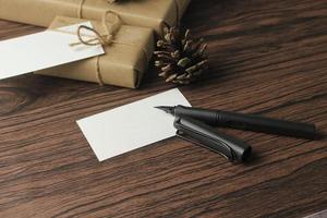 A birthday gift box wrapped in recycled paper is being prepared on the table. photo