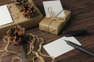 A birthday gift box wrapped in recycled paper is being prepared on the table. photo