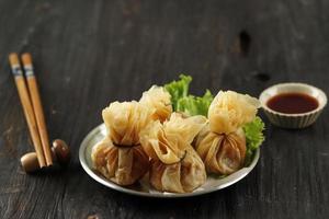 Ekado or Ekkado is Processed Fish or Shrimp Meat Wrapped in Dumpling Skin and Shaped like a Bag photo