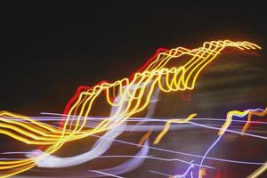 Long Exposure Photograph Of Vehicle Lights At Night In City photo