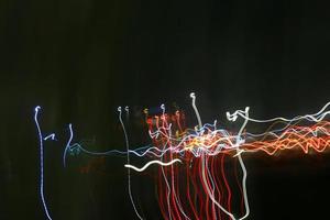 Long Exposure Photograph Of Vehicle Lights At Night In City photo