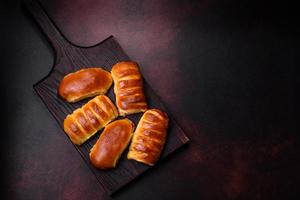 Sweet tasty fresh festive baking on a dark concrete background photo