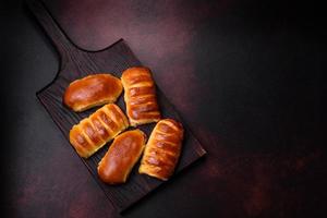 Sweet tasty fresh festive baking on a dark concrete background photo