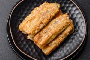 Fresh bite rolls from leaves of cabbage with minced meat, onions and carrots photo